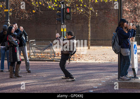 People taking photographs. Tourists photographing London, England, UK Stock Photo