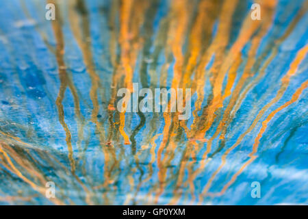 Abstract Iron Bleeding. Grunge Background of Old Blue and Orange Painted Metal. Rusty Metal Texture Background. Stock Photo