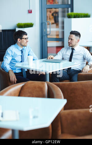 Businessmen talking in cafe Stock Photo