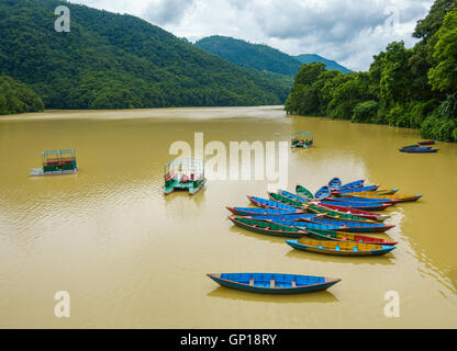 Colorful small boats on Phewa Lake in Pokhara, Nepal Stock Photo