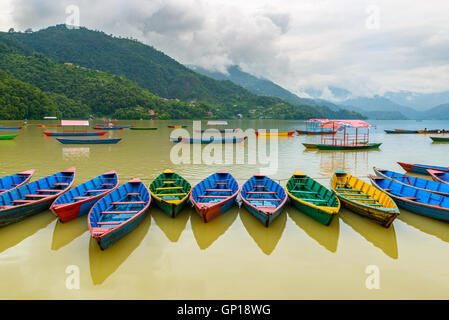Colorful small boats on Phewa Lake in Pokhara, Nepal Stock Photo