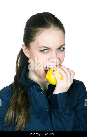 The girl with a sour mine on the person bites  lemon Stock Photo