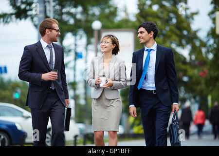 Happy managers discussing working plans outdoors Stock Photo