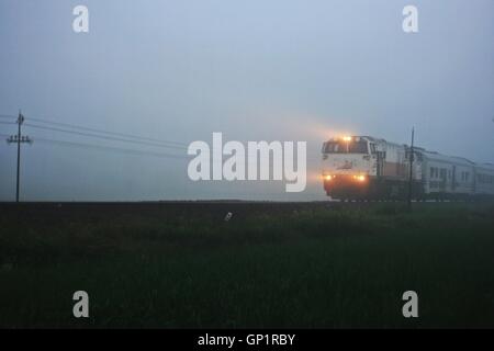 Indonesian train in the foggy morning Stock Photo