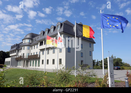 Parliament building of the German speaking Community in Eupen, Belgium. Flags from left to right: City of Eupen, German-speaking Community, Belgium, Europe Stock Photo