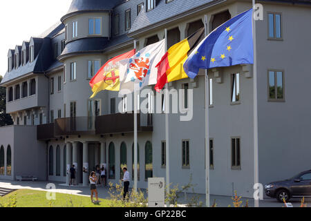 Parliament building of the German speaking Community in Eupen, Belgium. Flags from left to right: City of Eupen, German-speaking Community, Belgium, Europe Stock Photo