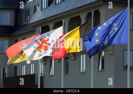 Parliament building of the German speaking Community in Eupen, Belgium. Flags from left to right: City of Eupen, German-speaking Community, Belgium, Europe Stock Photo