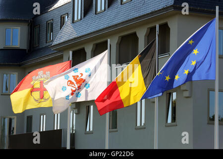 Parliament building of the German speaking Community in Eupen, Belgium. Flags from left to right: City of Eupen, German-speaking Community, Belgium, Europe Stock Photo