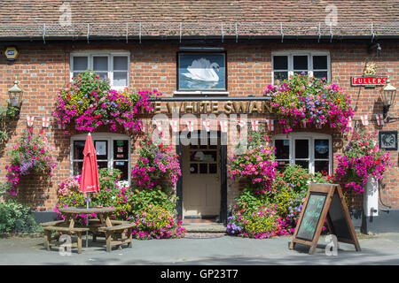 Floral hanging baskets on the front of The White Swan pub in Whitchurch Buckinghamshire, England Stock Photo