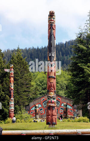 Carved cedar Tlingit totem poles and clan house detail Saxman Totem Park Ketchikan Tongass Narrows Inside Passage Southeast Alas Stock Photo