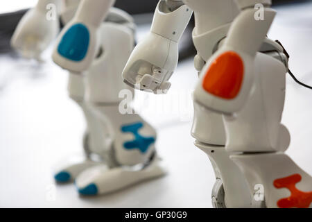 A small robot with human face and body - humanoid. Artificial Intelligence - AI. Blue robot. Hand and legs. Stock Photo