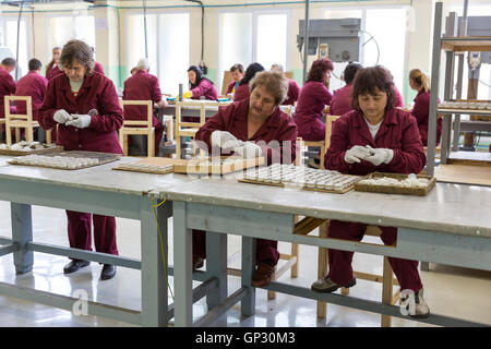 Sopot, Bulgaria - May 17, 2016: Arsenal women workers are producing weapons detonators in one of Bulgaria's arms factory. The fa Stock Photo