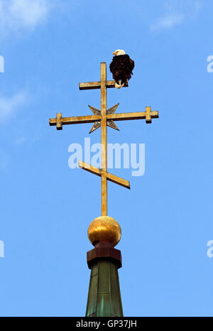 Bald Eagle on Dome and steeple cross St. Michael's Russian Orthodox Church Cathedral Sitka Inside Passage Southeast Alaska Stock Photo