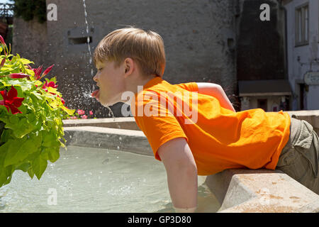 young boy drinking from a fountain, Meersburg, Lake Constance, Baden-Wuerttemberg, Germany Stock Photo