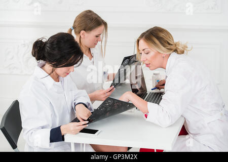 Group Of Doctors Having Meeting In A Hospital office examining x-ray Stock Photo