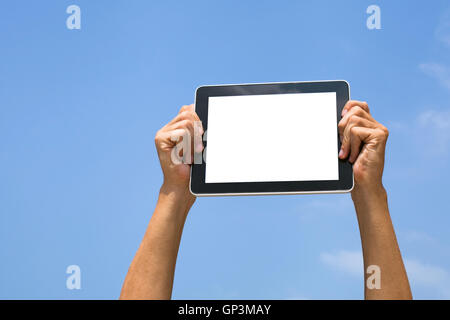 hands holding tablet with blank empty white screen on blue sky background Stock Photo
