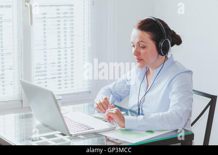 business woman participating online video conference in the office Stock Photo