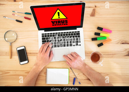 virus alert sign on the screen of computer, top view of workplace desktop Stock Photo