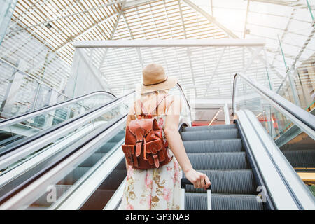 woman in modern airport, people traveling with luggage Stock Photo