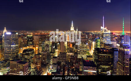 New York City skyline illuminated at night, USA Stock Photo