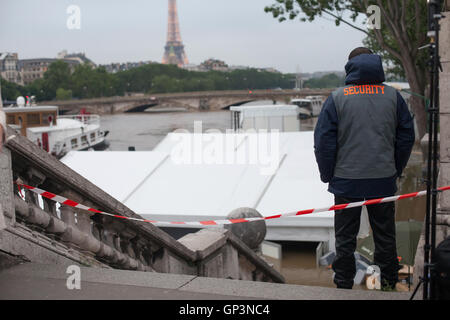 flood in Paris, Seine river, unidentified security person standing on the stairs of bridge Alexandre, June 2016, France Stock Photo