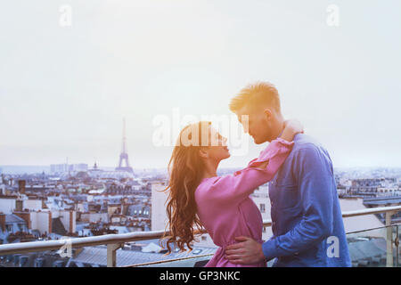 romantic couple in Paris, happy moment on Eiffel Tower background, honeymoon Stock Photo