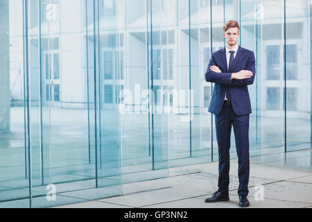 businessman standing on abstract business background, full body portrait Stock Photo
