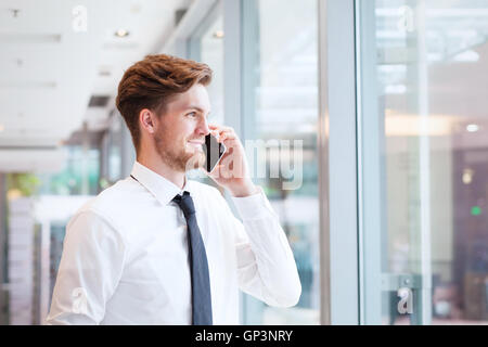 businessman talking on phone and smiling Stock Photo