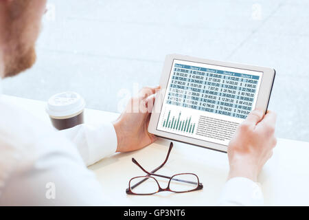 business man reading financial report on tablet Stock Photo