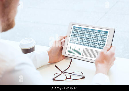 business man reading financial report on tablet Stock Photo