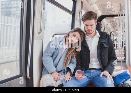 couple in metro, young commuters sitting together Stock Photo