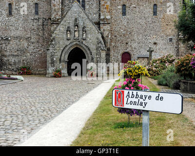 Approach and entrance to Abbaye de Lonlay a spectacular medieval church in Lonlay-l'Abbaye, near Domfront, Normandy France Stock Photo