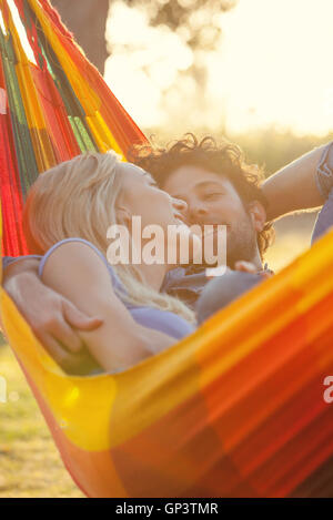 Couple relaxing together in hammock Stock Photo