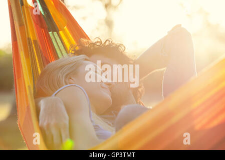 Couple napping together in hammock Stock Photo