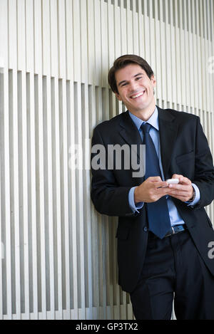 Businessman relaxing with smartphone Stock Photo