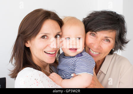 Smiling grandmother, mother and baby, portrait Stock Photo