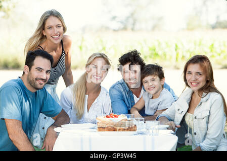 Family having picnic together outdoors, group portrait Stock Photo