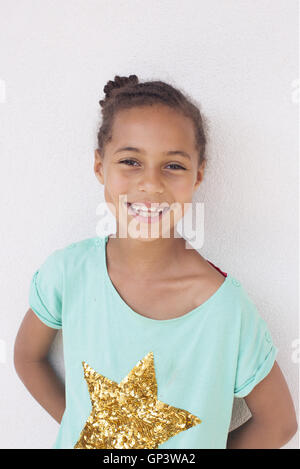 Studio portrait of a happy girl with arms raised on air Stock Photo - Alamy