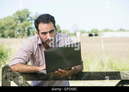 Man using laptop computer outdoors Stock Photo