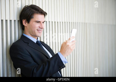 Businessman relaxing with smartphone Stock Photo