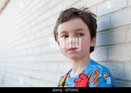 Boy looking away in thought, portrait Stock Photo