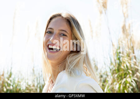 Woman laughing outdoors, portrait Stock Photo