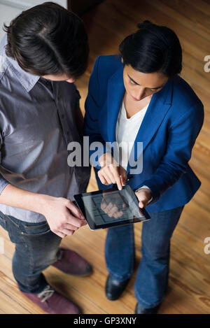 Showing client houseplan options using digital tablet Stock Photo
