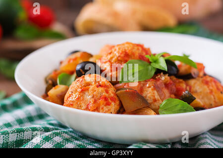 Juicy meatballs of turkey meat with vegetables (zucchini, eggplant, olive, tomato) Stock Photo