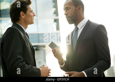 Businessmen talking outdoors Stock Photo