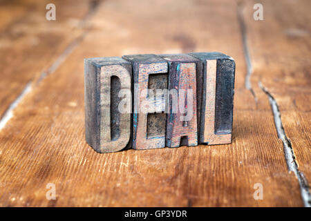 deal word made from wooden letterpress type on grunge wood Stock Photo