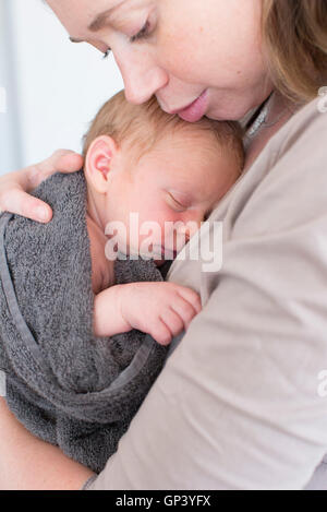 Mother holding infant Stock Photo