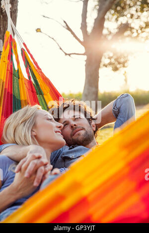 Couple relaxing together in hammock Stock Photo
