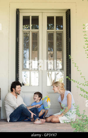 Family with one child having lighthearted time together outdoors Stock Photo