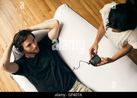 Couple exploring possibilities with multimedia smartphone Stock Photo